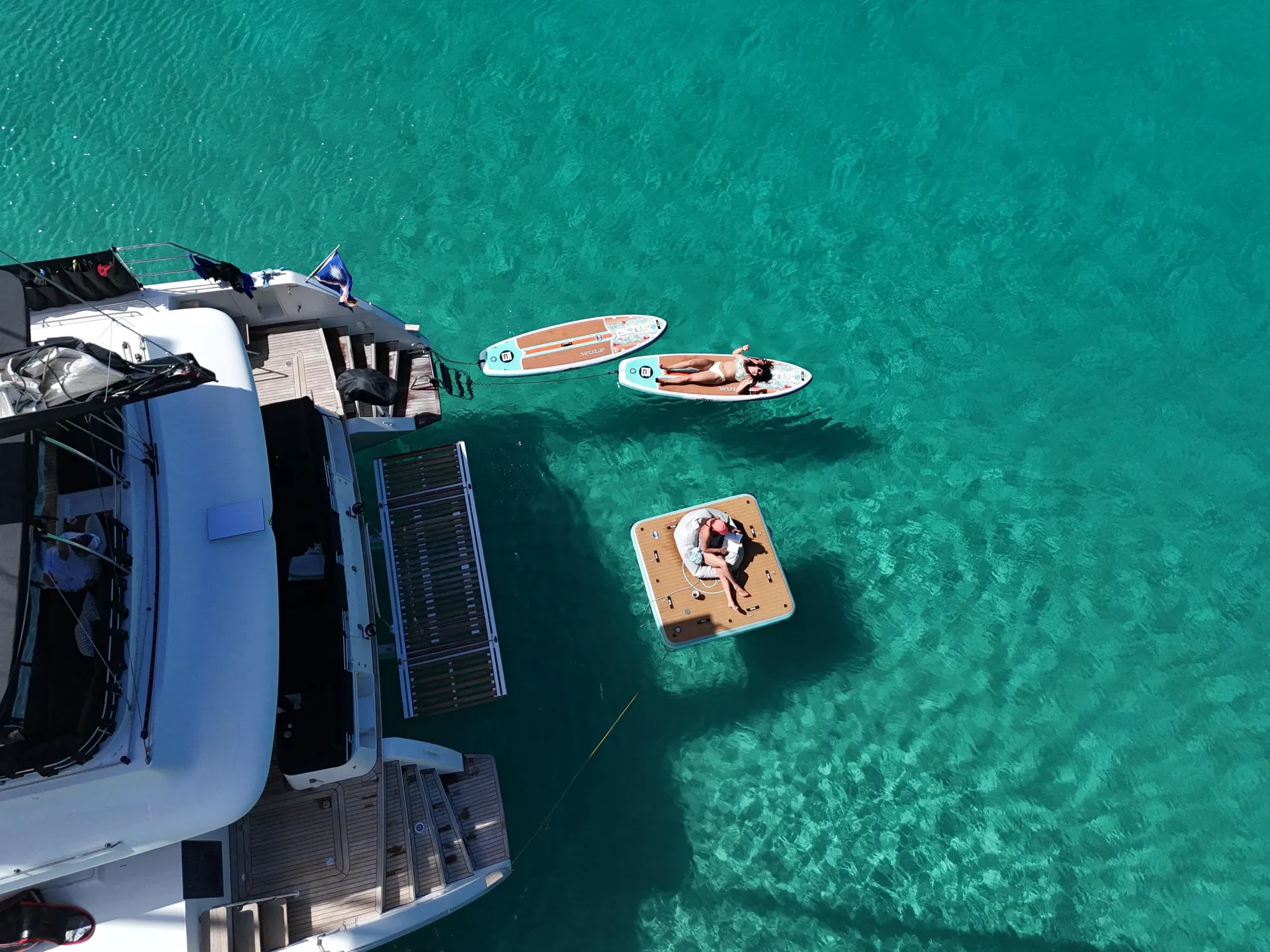 Guests enjoying water toys from the catamaran