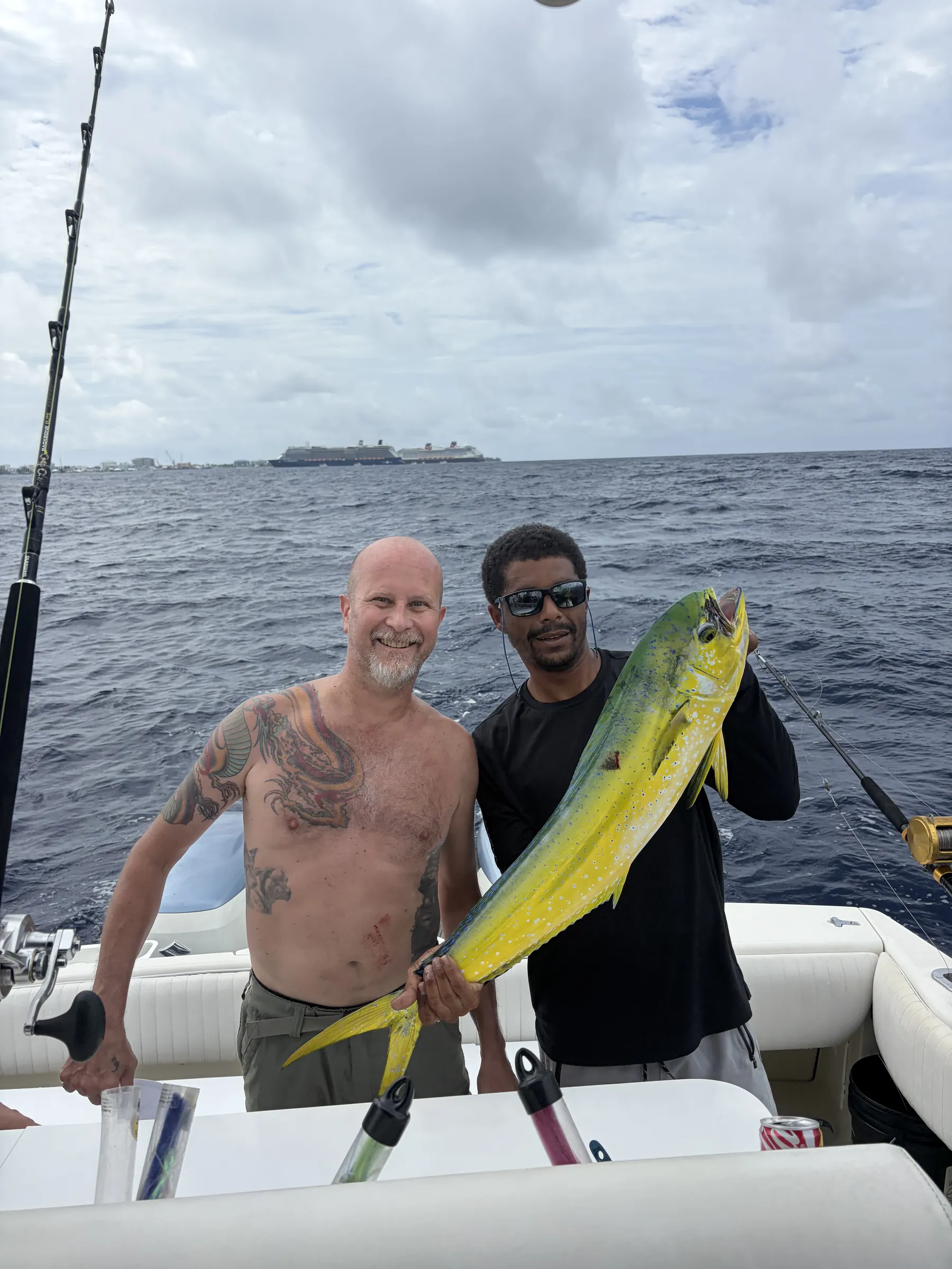 Guest and crew member with a mahi-mahi aboard Mojito Majic
